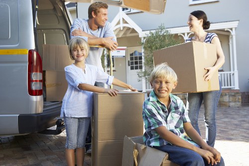 Affordable student removals team handling boxes in Mileend