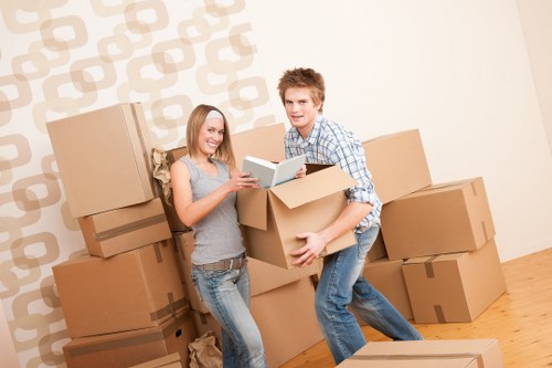 Professional packing service preparing fragile items with boxes in Mileend