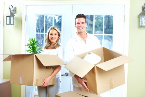 Commercial movers transporting office furniture and IT assets for a Mileend relocation